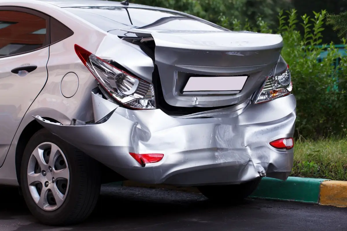 Silver car with severe rear-end damage after a traffic collision, representing a car accident and property damage claim.