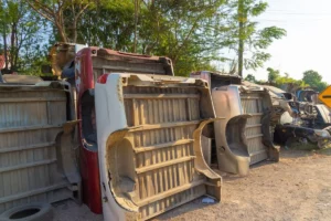 Damaged and overturned car bodies stacked in a junkyard after severe auto accidents.